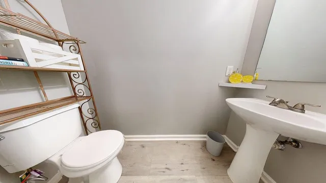 a bathroom with a sink a toilet and a window