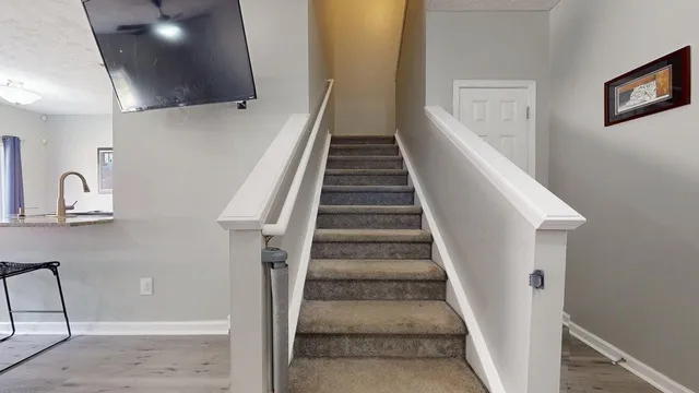 a view of entryway and hall with wooden floor