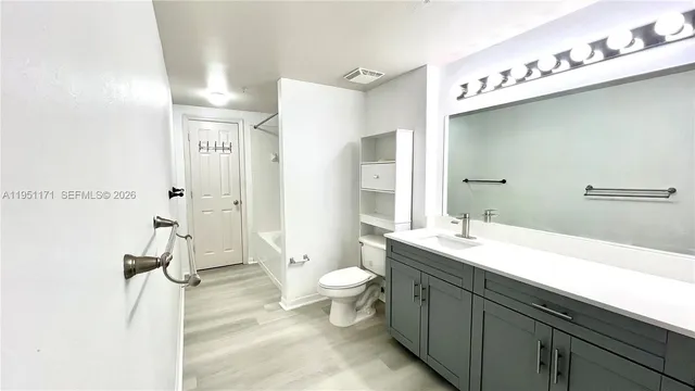 a spacious bathroom with a double vanity sink toilet and shower