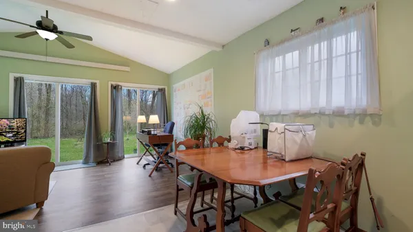 a dining room with furniture and wooden floor