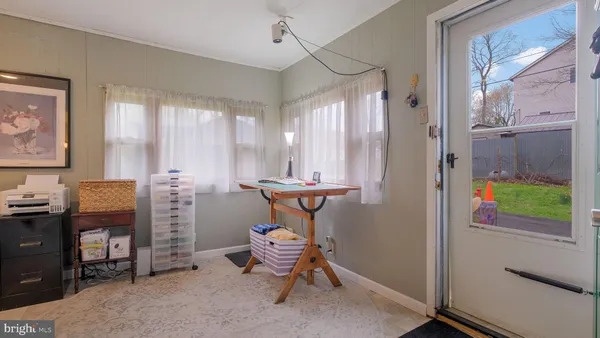 a view of a livingroom with furniture and a window