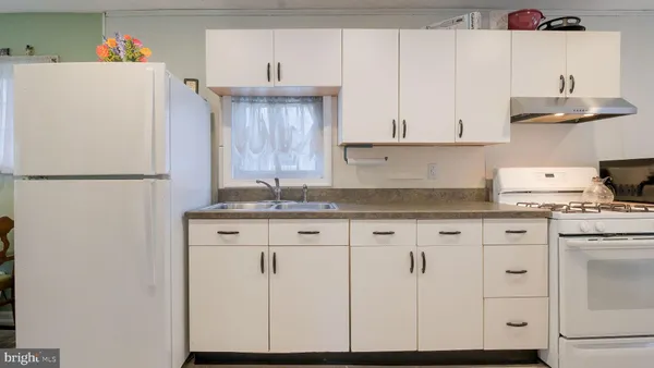 a kitchen with stainless steel appliances kitchen island granite countertop a refrigerator and microwave