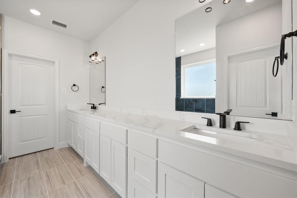 3400 Dobbins Road Corsicana, TX 75110 - Photo 20 of 40 a bathroom with double vanity sink and a mirror