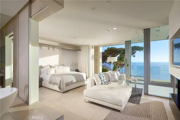 a living room with patio furniture and a potted plant