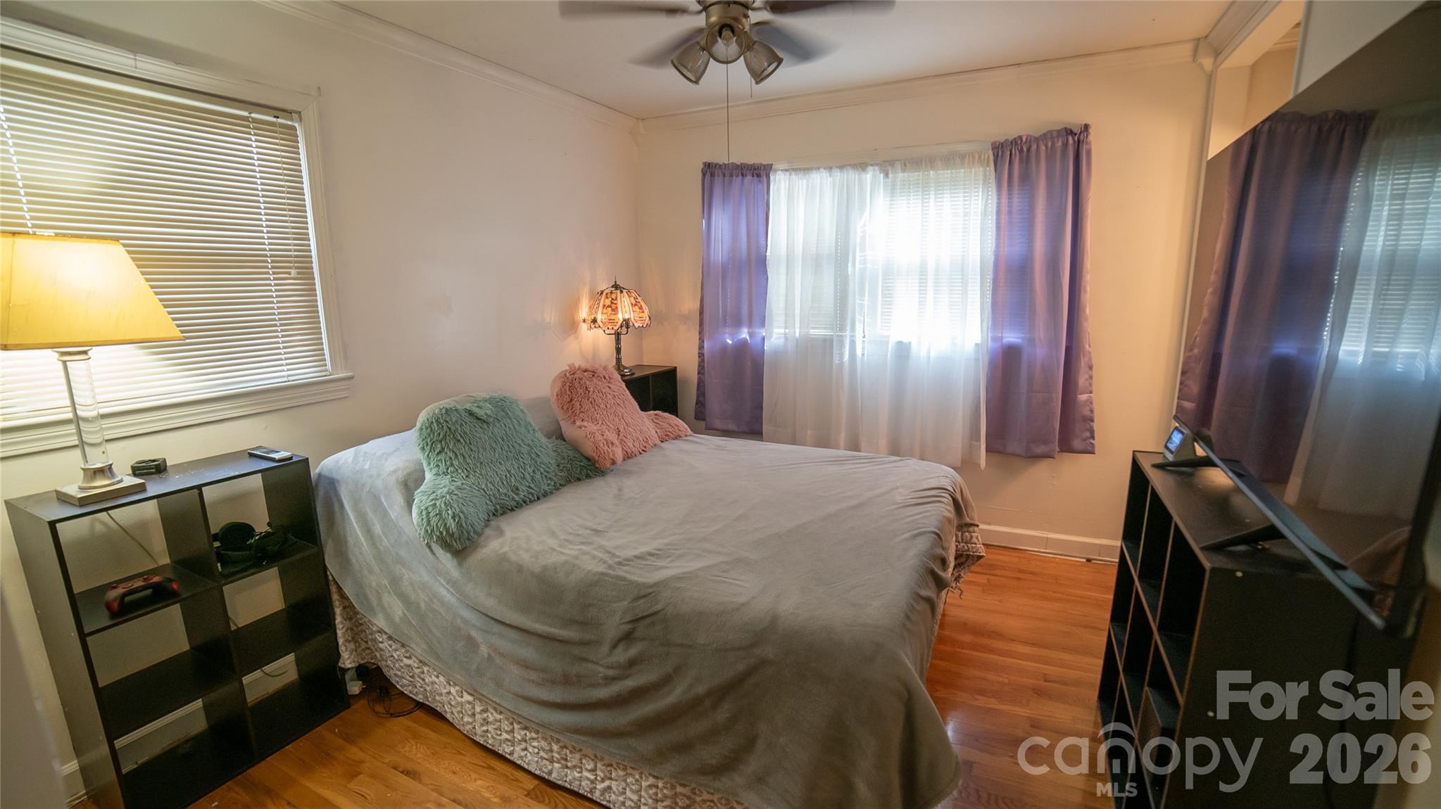 324 Golf Course Road Morganton, NC 28655 - Photo 12 of 21 a bedroom with a bed and a chandelier