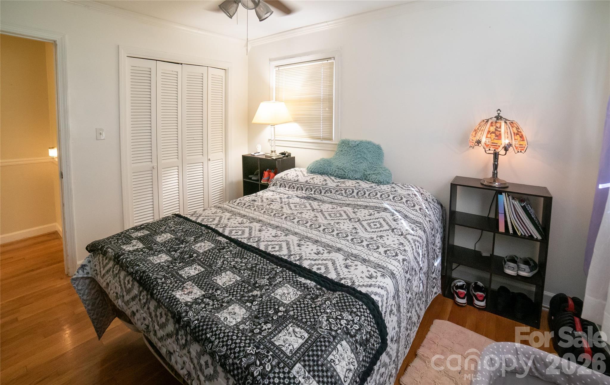 324 Golf Course Road Morganton, NC 28655 - Photo 13 of 21 a bedroom with a bed and a chandelier