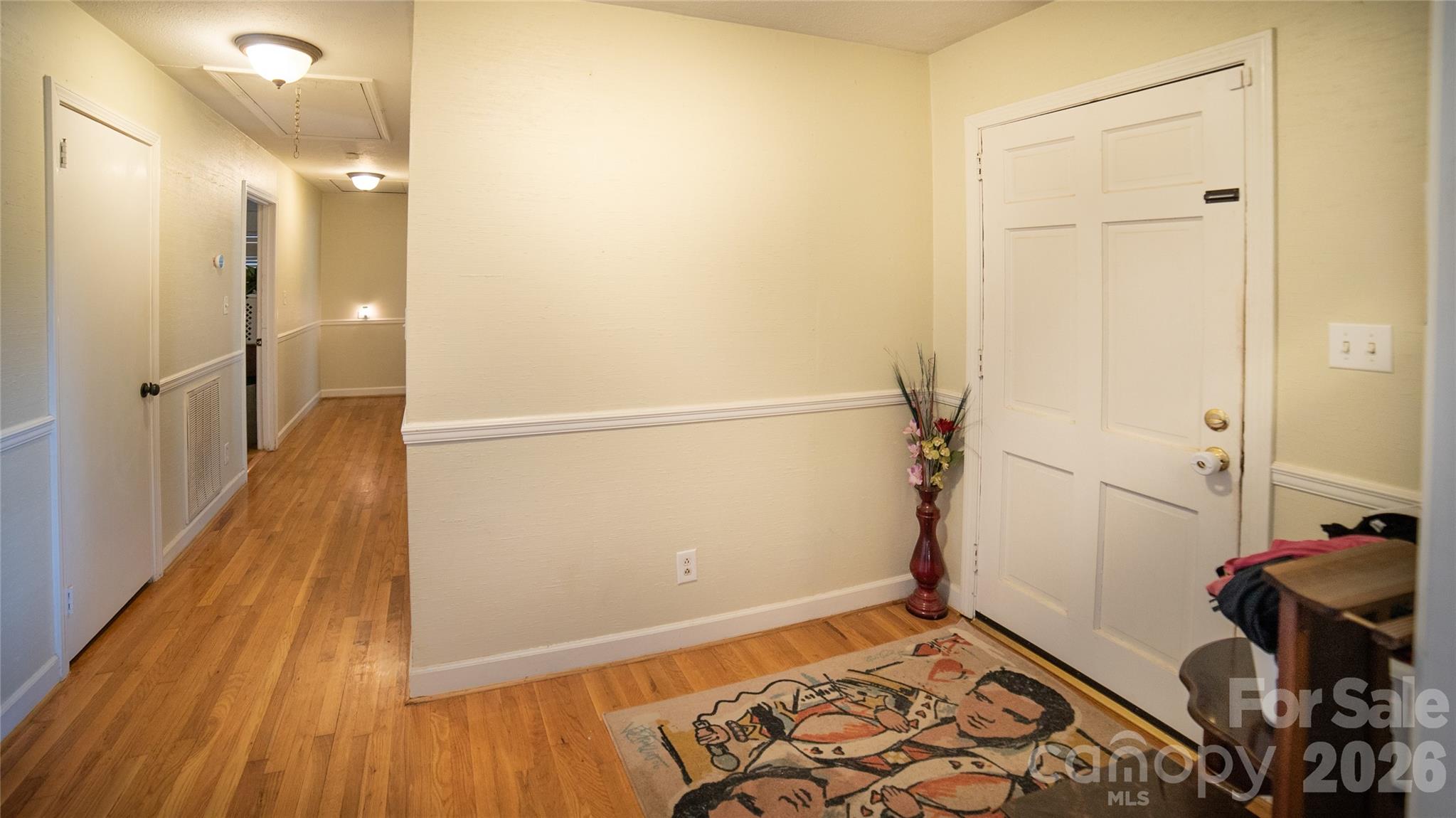 324 Golf Course Road Morganton, NC 28655 - Photo 5 of 21 a view of a hallway with wooden floor and a bathroom