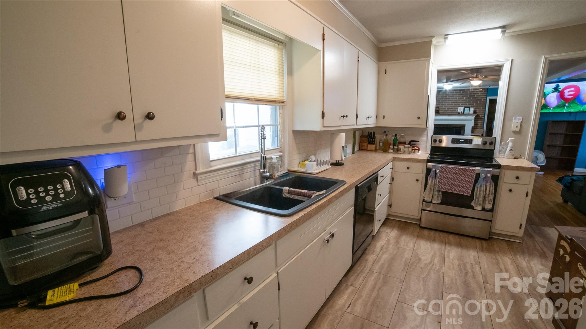 324 Golf Course Road Morganton, NC 28655 - Photo 8 of 21 a kitchen with a stove a sink and a microwave