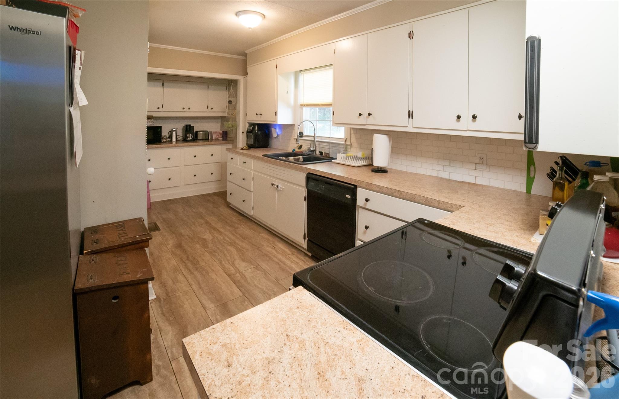 324 Golf Course Road Morganton, NC 28655 - Photo 9 of 21 a kitchen with a sink stove and cabinets