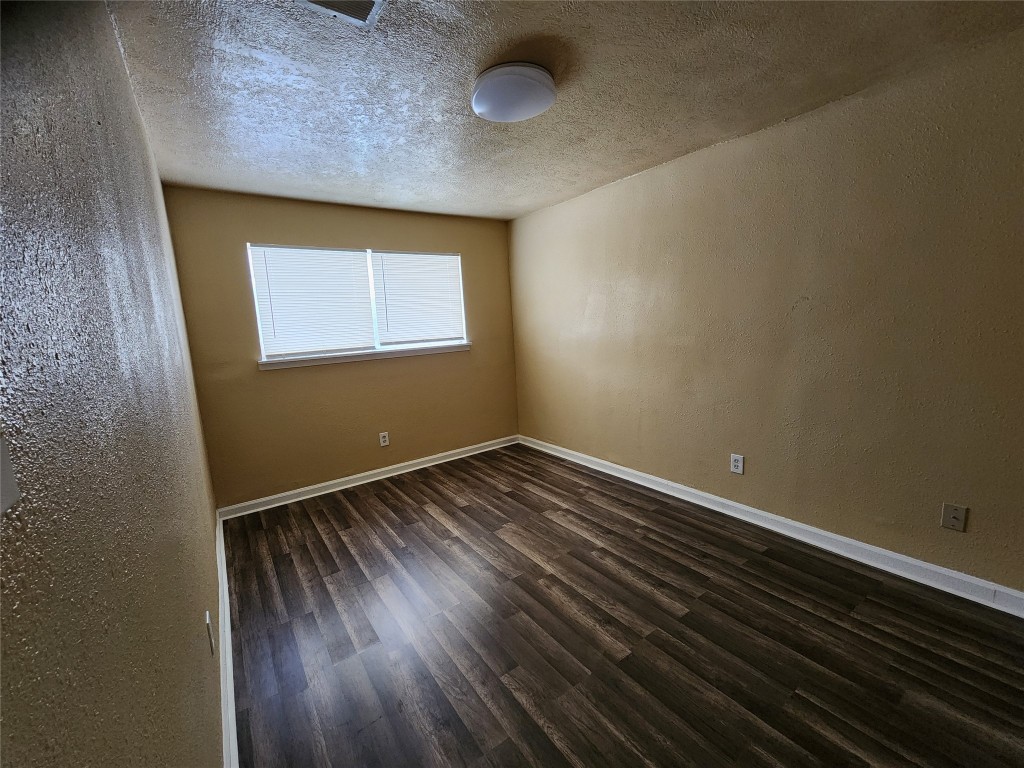 4311 Yellowstone Boulevard, Unit 5 Houston, TX 77021 - Photo 5 of 8 a view of an empty room with wooden floor and a window