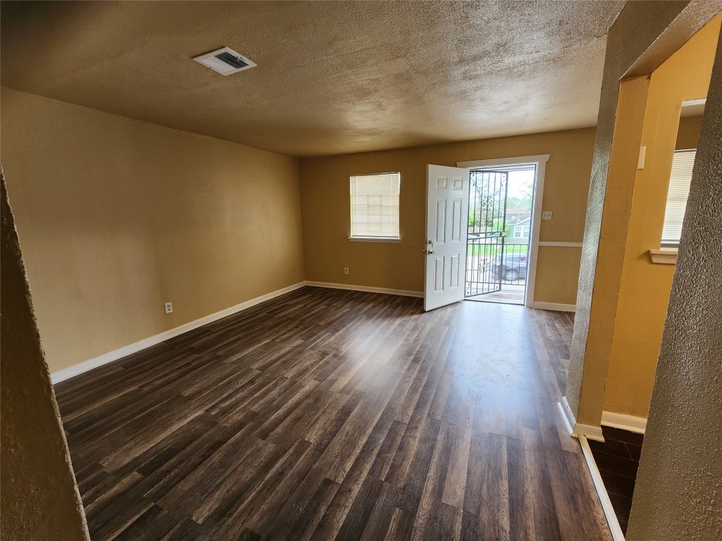 4311 Yellowstone Boulevard, Unit 5 Houston, TX 77021 - Photo 7 of 8 a view of an empty room with wooden floor and a window