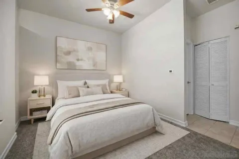 a bedroom with a large bed and a chandelier