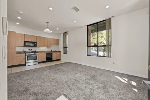 a large kitchen with stainless steel appliances granite countertop a stove and a sink with granite countertops