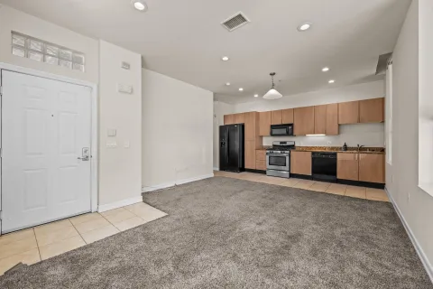 a view of kitchen with stainless steel appliances granite countertop a refrigerator oven a sink and dishwasher