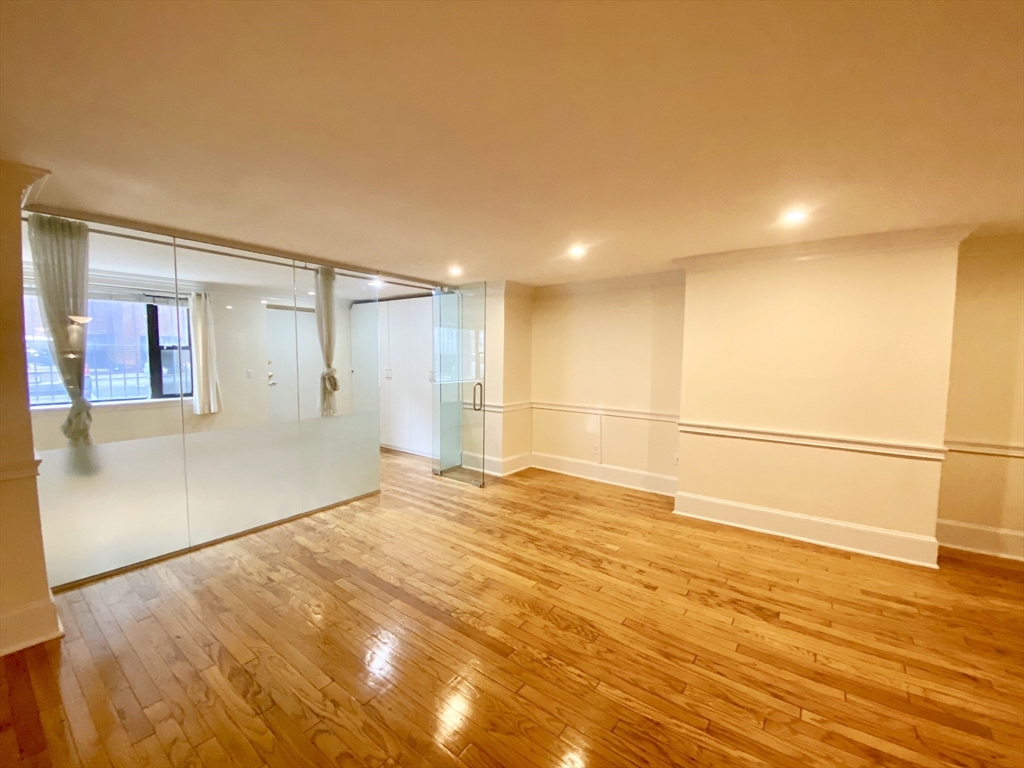 280 Commonwealth Avenue, Unit G8 Boston, MA 02116 - Photo 1 of 12 a view of an empty room with wooden floor