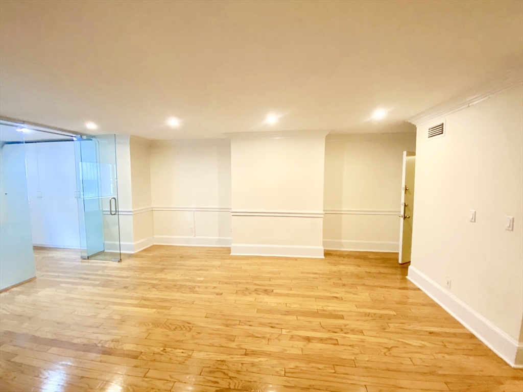 280 Commonwealth Avenue, Unit G8 Boston, MA 02116 - Photo 3 of 12 a view of an empty room with a kitchen