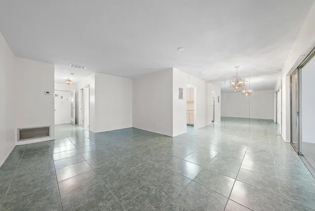a view of a kitchen with a sink and a refrigerator