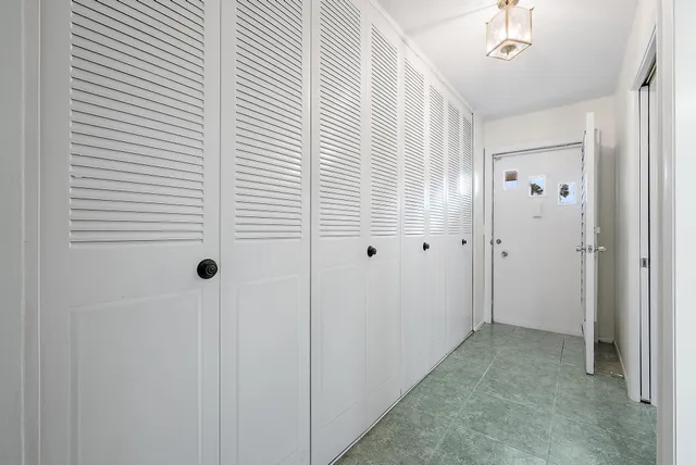 a view of a hallway with closet and entryway