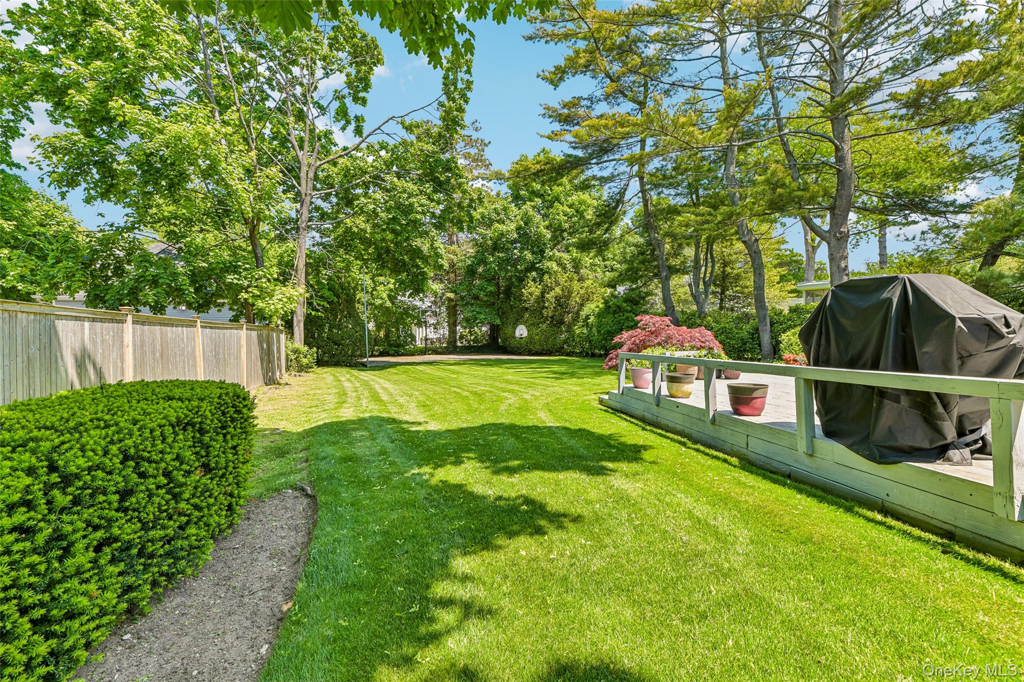 100 Hewlett Neck Road Woodmere, NY 11598 - Photo 41 of 45 a view of yard with swimming pool and trees in the background