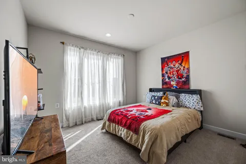 a living room with furniture pool table and a flat screen tv
