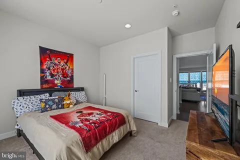 a living room with furniture kitchen and a flat screen tv