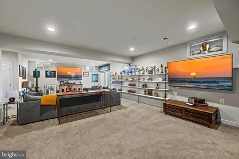 a front view of house with yard barbeque and outdoor seating