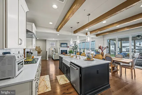 a kitchen with kitchen island stainless steel appliances a sink stove and cabinets