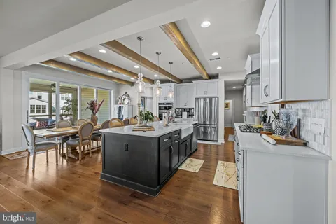 a kitchen with stainless steel appliances kitchen island granite countertop a lot of counter space and a sink