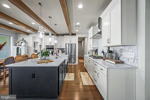 a kitchen with stainless steel appliances kitchen island granite countertop a sink and cabinets