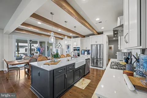 a large kitchen with lots of counter and chairs
