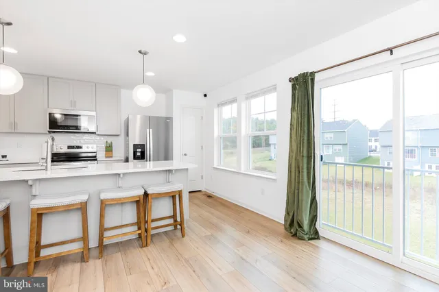 a kitchen with stainless steel appliances granite countertop a sink refrigerator and microwave