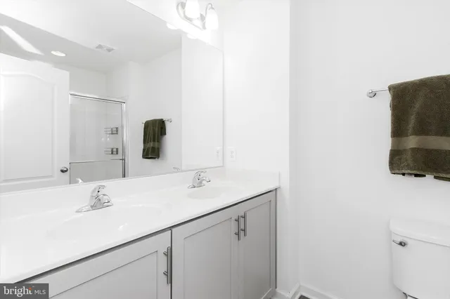 a bathroom with a glass shower door