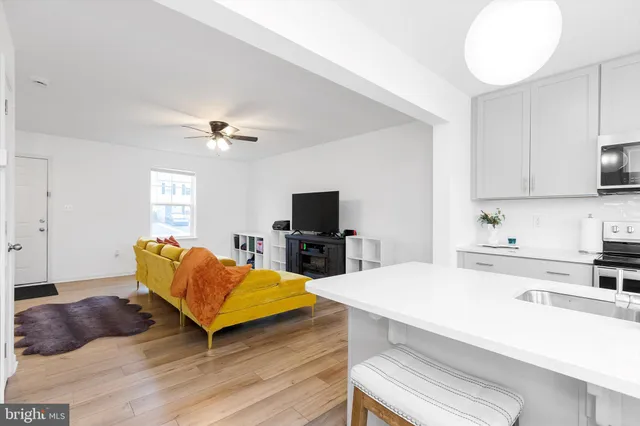 a kitchen with kitchen island a sink stainless steel appliances and cabinets