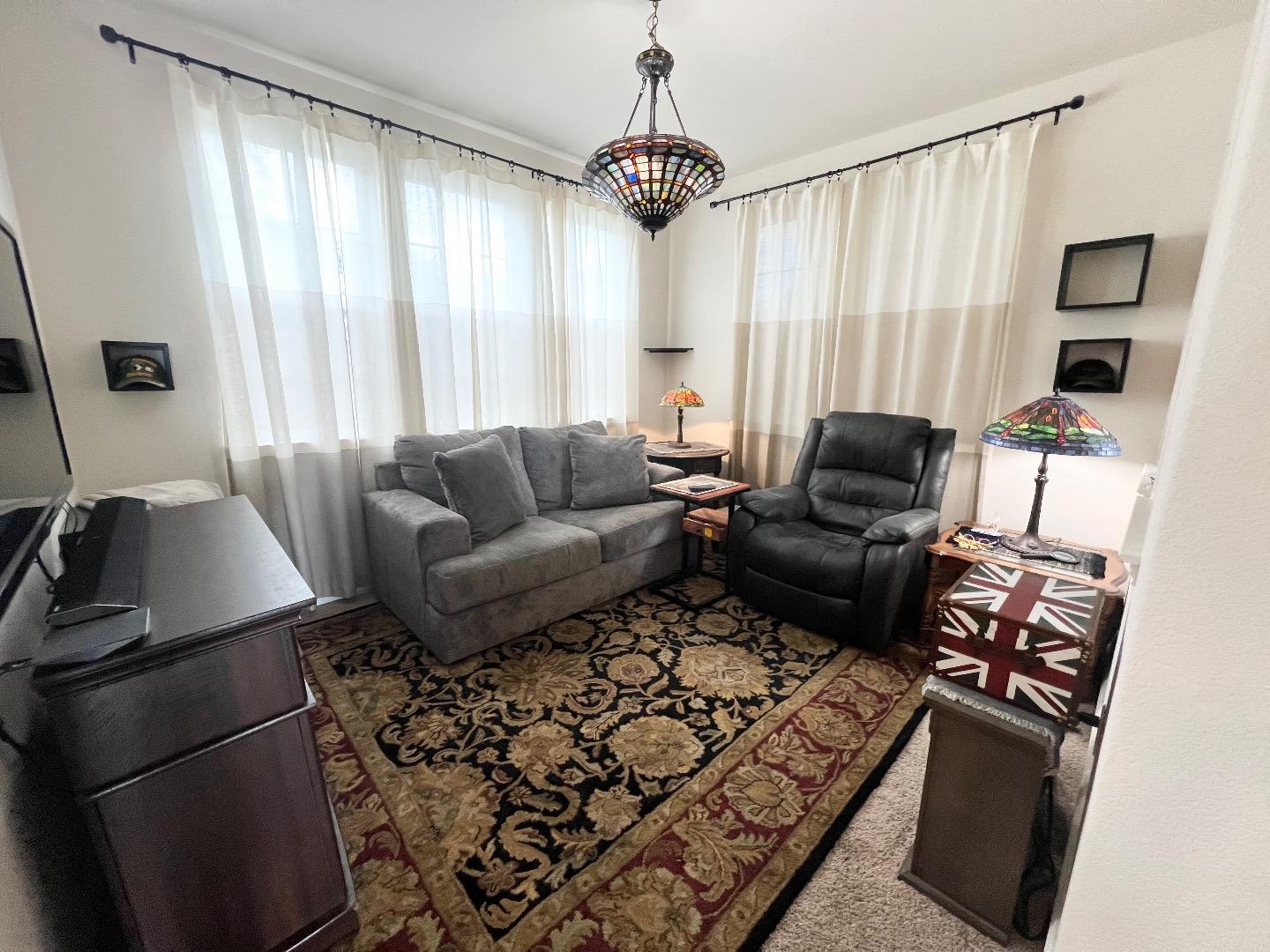 18643 McClellan Circle East Garrison, CA 93933 - Photo 24 of 42 a living room with furniture windows and a chandelier
