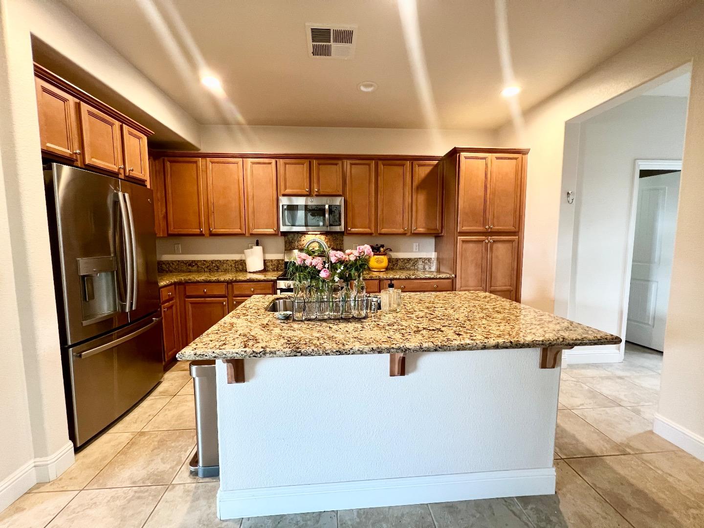 18643 McClellan Circle East Garrison, CA 93933 - Photo 29 of 42 a kitchen with kitchen island a counter top a sink appliances and cabinets
