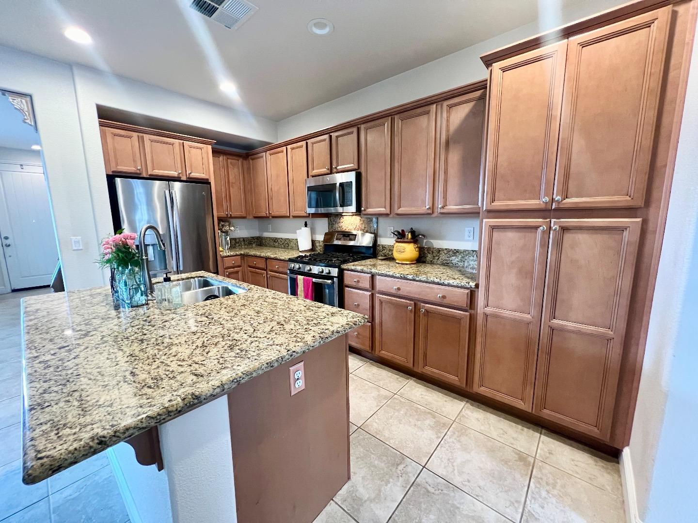 18643 McClellan Circle East Garrison, CA 93933 - Photo 30 of 42 a kitchen with stainless steel appliances granite countertop a refrigerator sink and cabinets