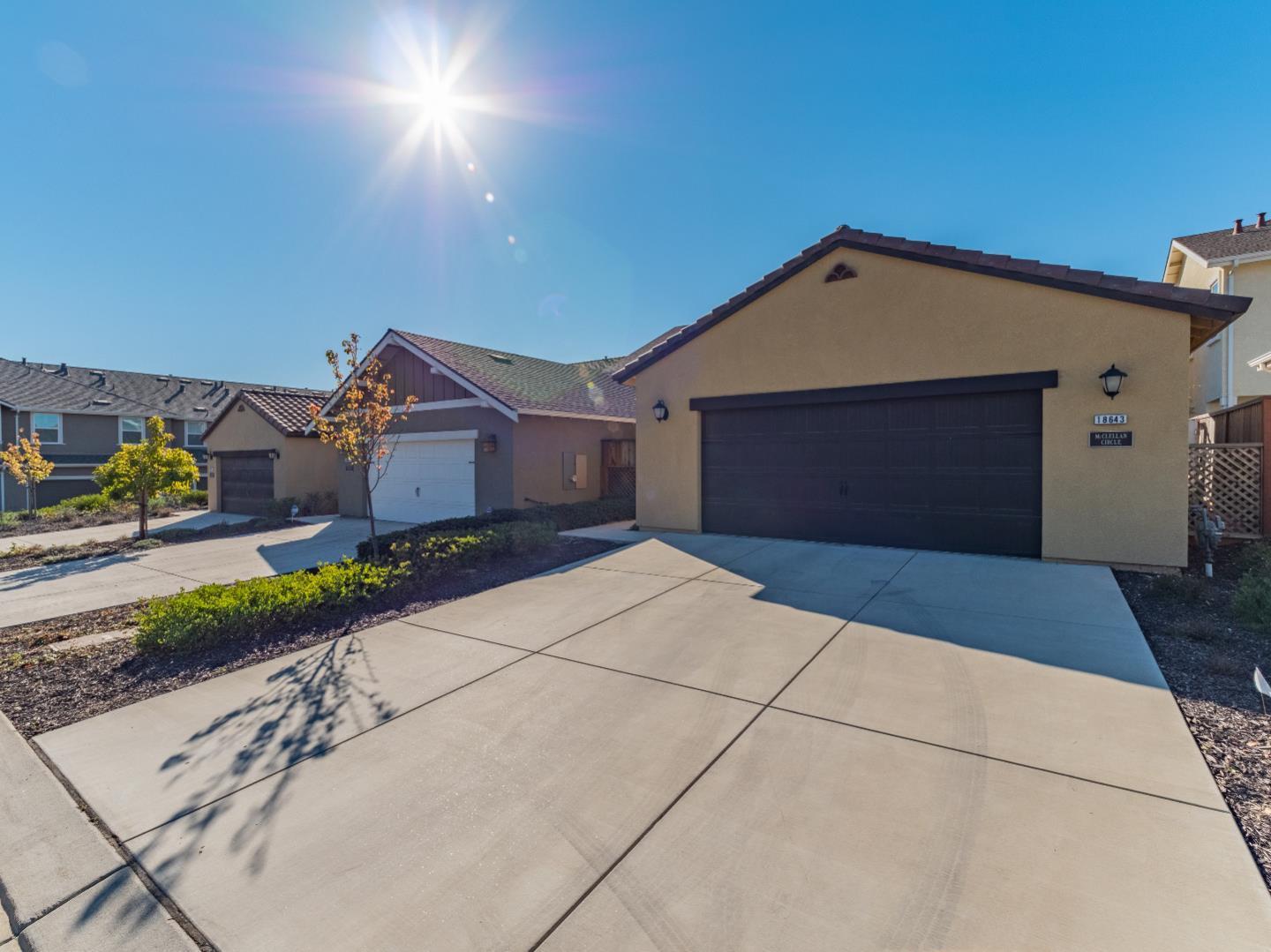 18643 McClellan Circle East Garrison, CA 93933 - Photo 3 of 42 a front view of a house with a yard and garage