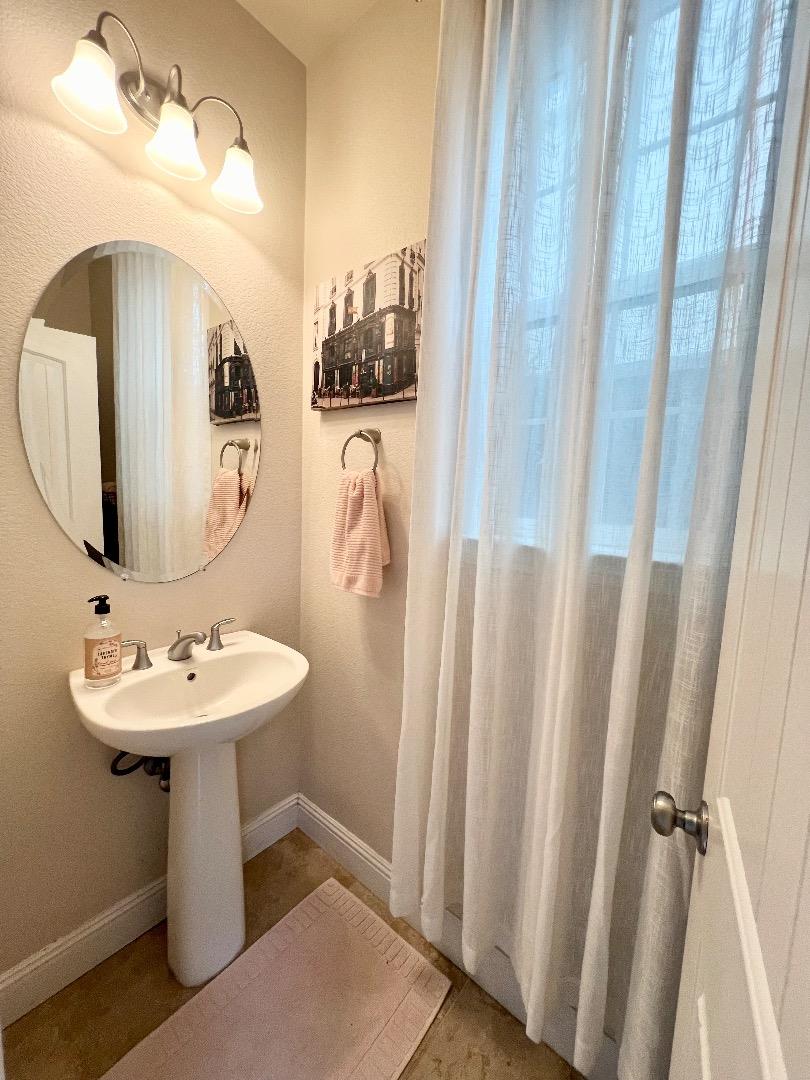 18643 McClellan Circle East Garrison, CA 93933 - Photo 32 of 42 a bathroom with a sink a mirror a vanity and shower