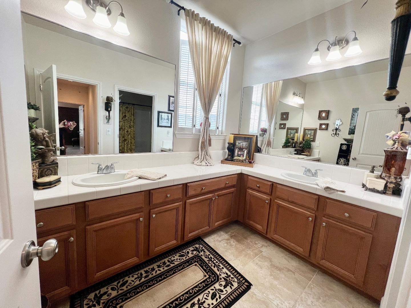 18643 McClellan Circle East Garrison, CA 93933 - Photo 33 of 42 a spacious bathroom with double vanity and mirrors