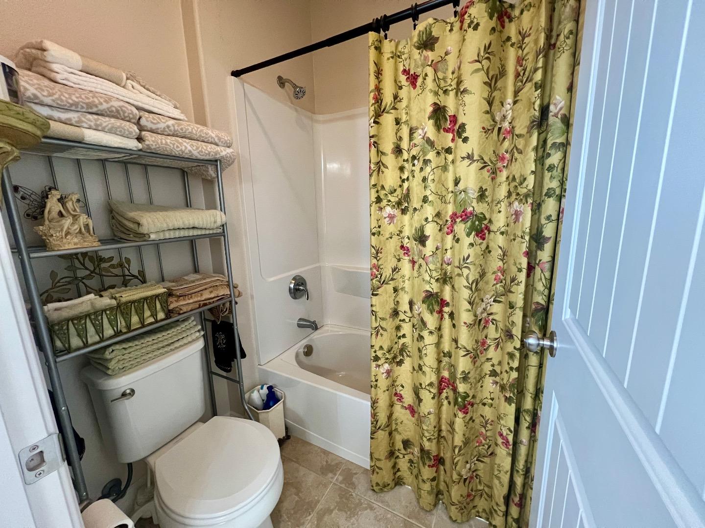 18643 McClellan Circle East Garrison, CA 93933 - Photo 34 of 42 a white toilet sitting next to a shower curtain