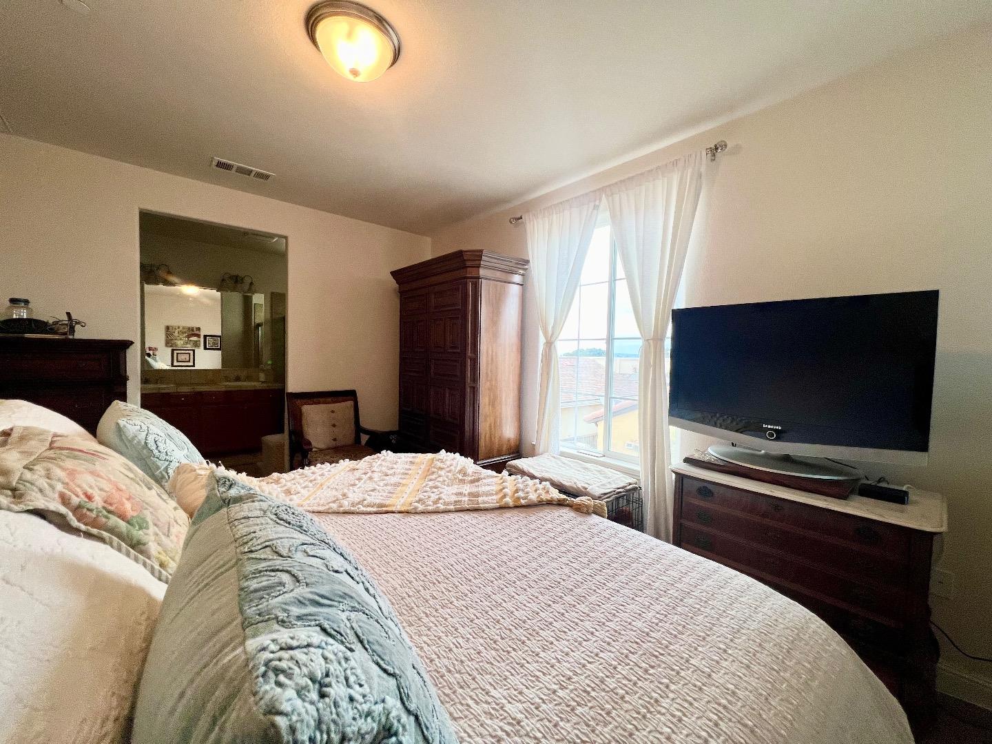 18643 McClellan Circle East Garrison, CA 93933 - Photo 36 of 42 a bedroom with a bed and a flat screen tv