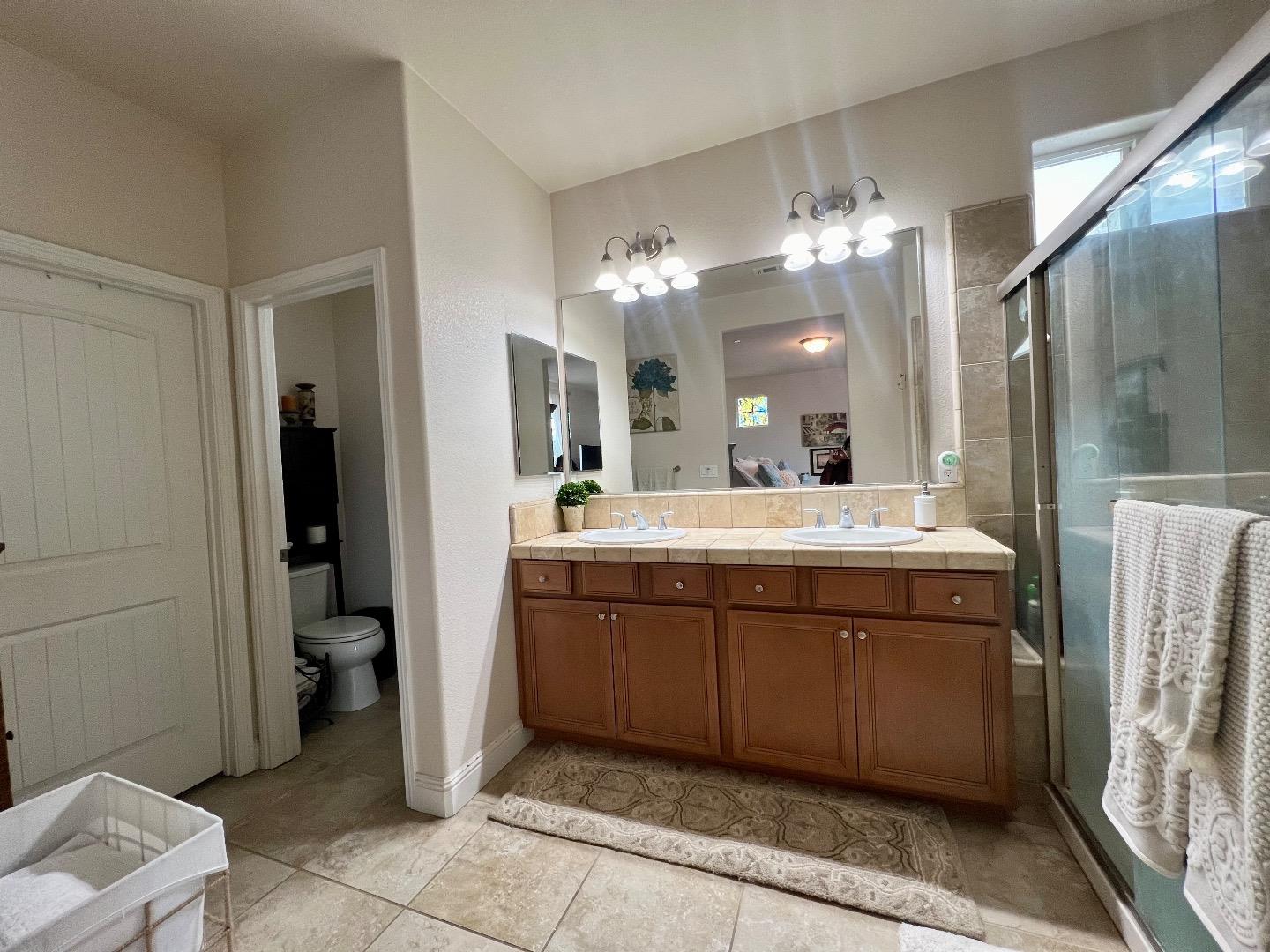18643 McClellan Circle East Garrison, CA 93933 - Photo 37 of 42 a bathroom with a double vanity sink and a mirror