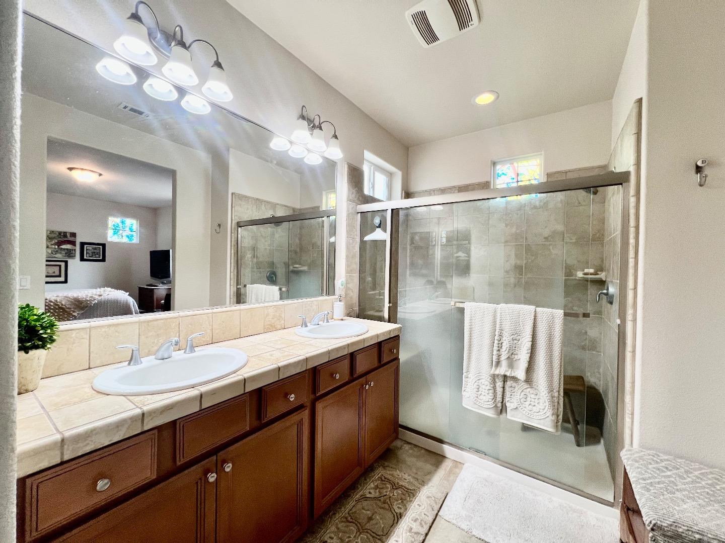 18643 McClellan Circle East Garrison, CA 93933 - Photo 38 of 42 a bathroom with a granite countertop sink mirror and vanity