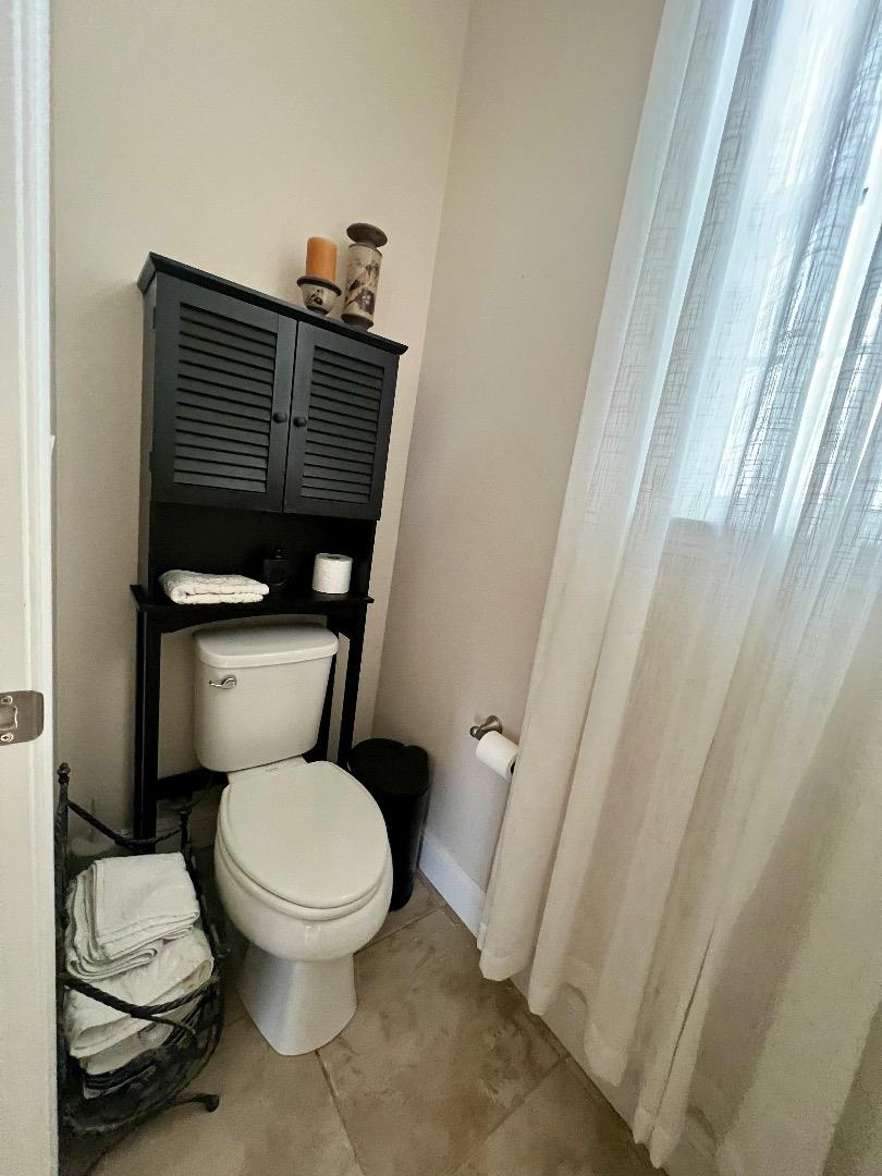 18643 McClellan Circle East Garrison, CA 93933 - Photo 39 of 42 a white toilet sitting next to a shower curtain