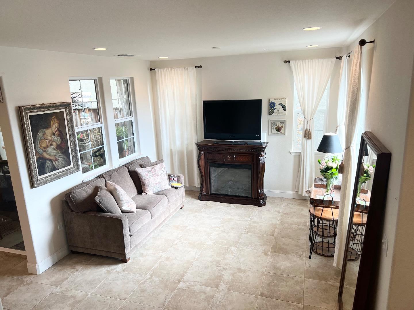 18643 McClellan Circle East Garrison, CA 93933 - Photo 41 of 42 a living room with furniture a flat screen tv and a fireplace