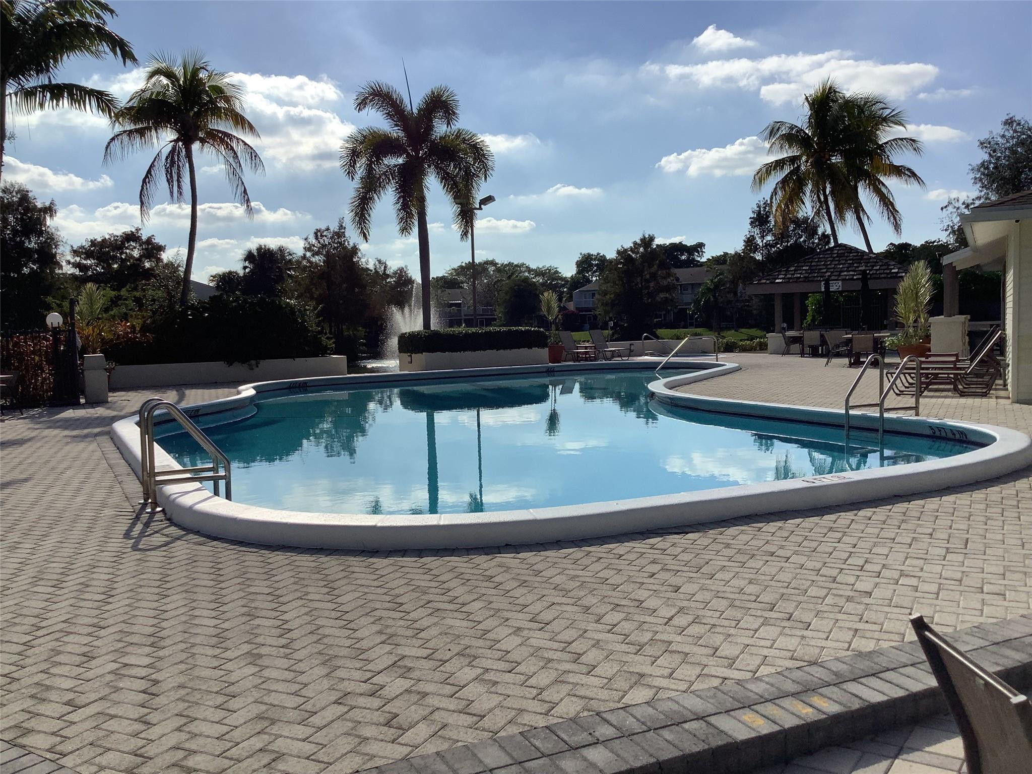 4765 South Hemingway Circle, Unit 68 Margate, FL 33063 - Photo 26 of 39 a view of a swimming pool with a chair
