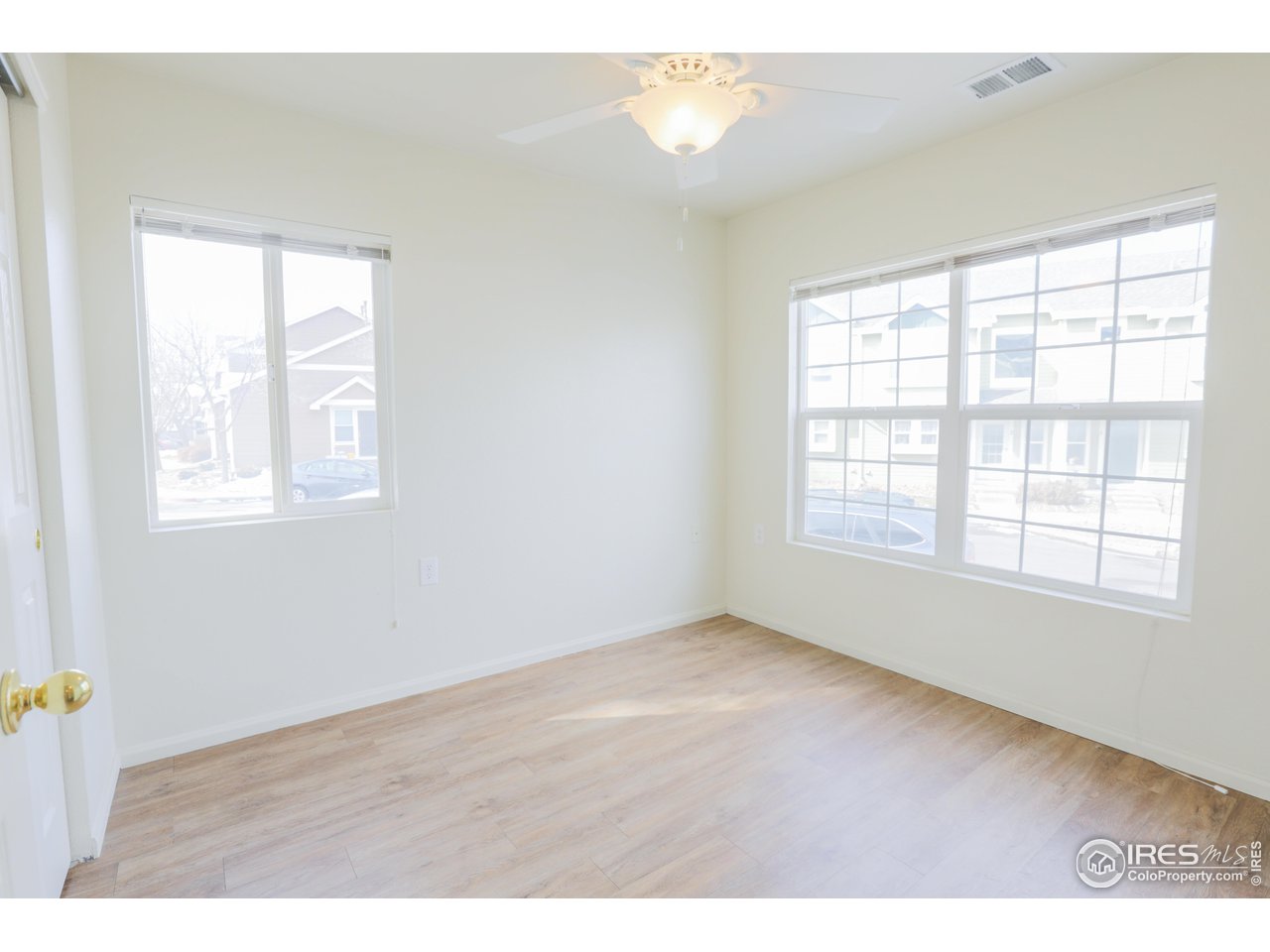 6827 Autumn Ridge Drive, Unit 4 Fort Collins, CO 80525 - Photo 15 of 28 an empty room with wooden floor and windows