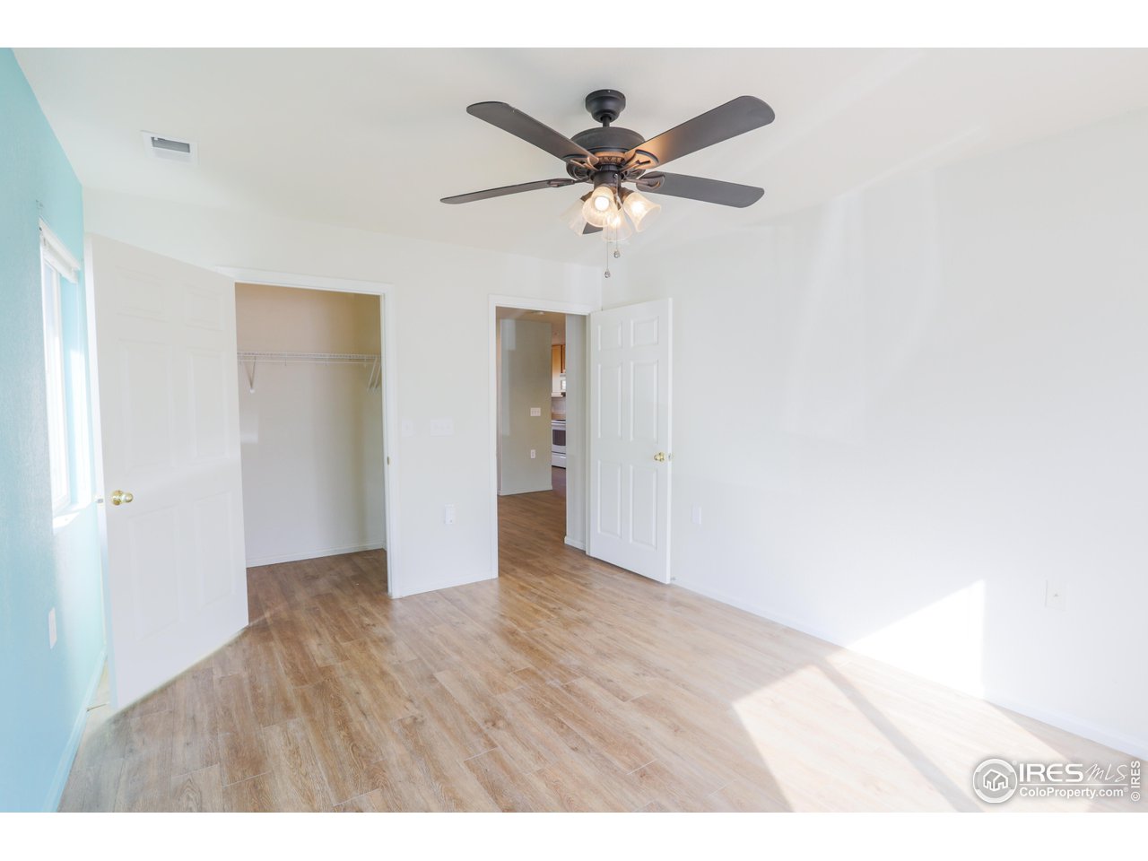6827 Autumn Ridge Drive, Unit 4 Fort Collins, CO 80525 - Photo 19 of 28 a view of an empty room with wooden floor