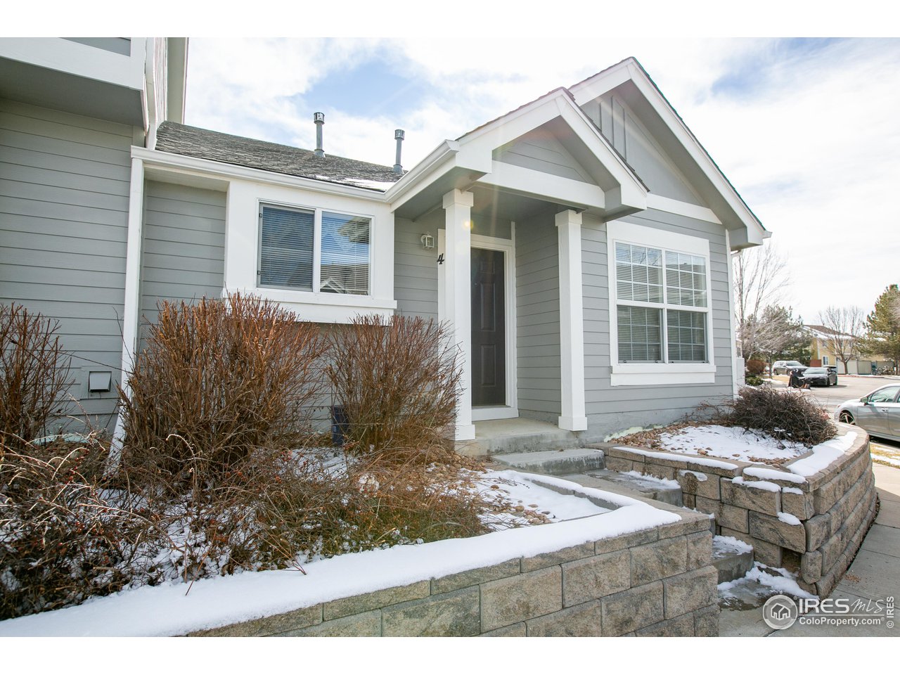6827 Autumn Ridge Drive, Unit 4 Fort Collins, CO 80525 - Photo 3 of 28 a front view of a house with a yard