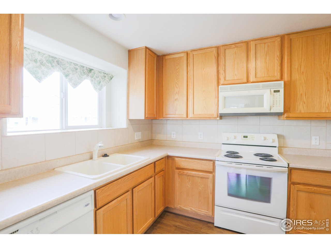 6827 Autumn Ridge Drive, Unit 4 Fort Collins, CO 80525 - Photo 9 of 28 a kitchen with a sink stove top oven and cabinets